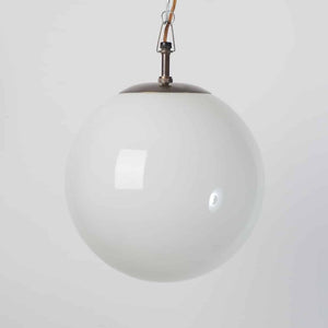 White globe lights with brass fittings