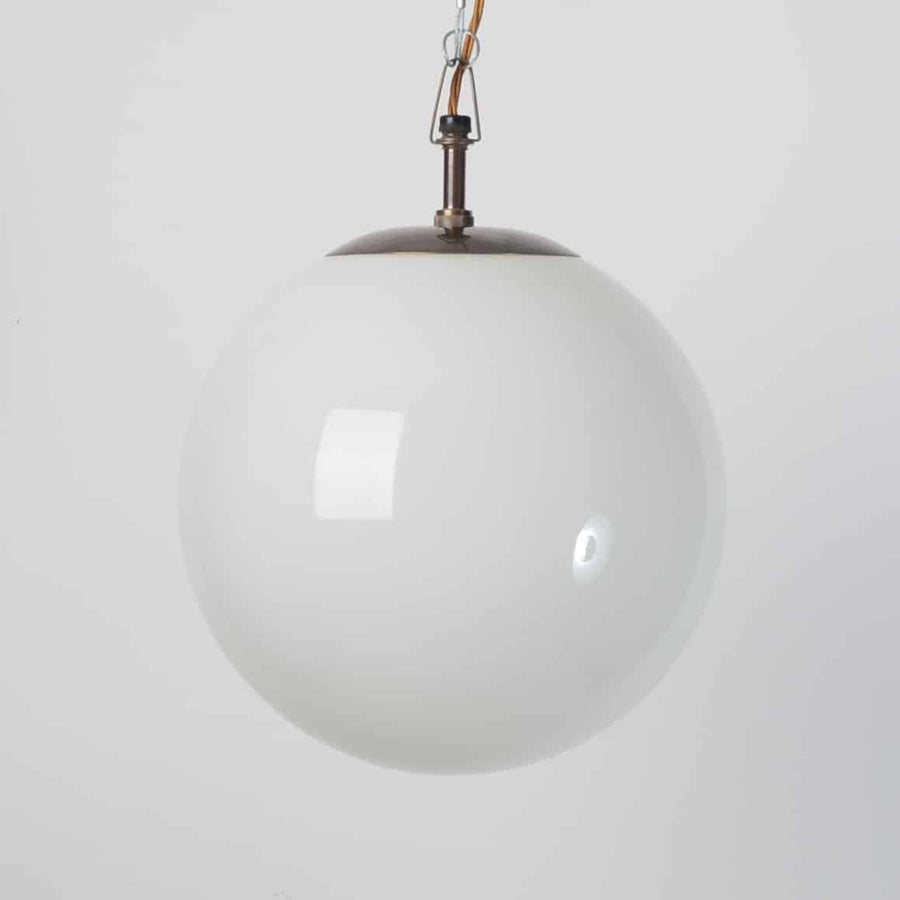 White globe lights with brass fittings