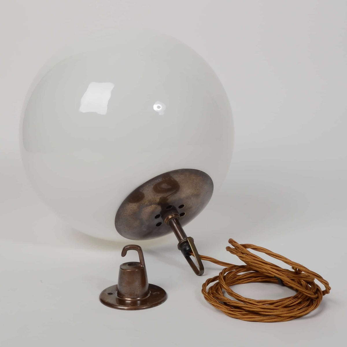 White globe lights with brass fittings